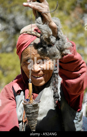 Portrait sympathique tibétain femme tourne broche en laine avec un Nar-Phu Région Annapurna Népal Banque D'Images