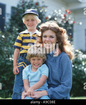 Jeune mère avec son fils et sa fille dans une cour Banque D'Images