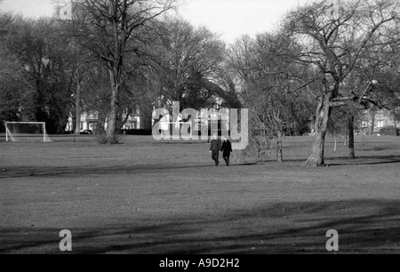 Avis de Hendon Park avec jeune couple marche main dans la main le nord de Londres Angleterre Royaume-Uni Europe Banque D'Images