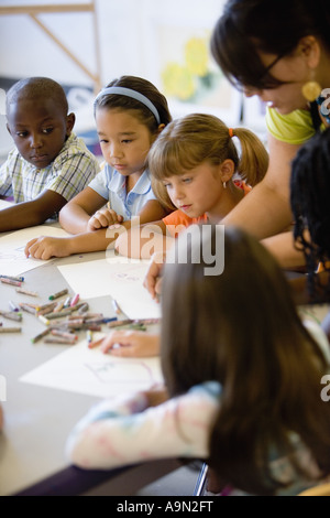 Garçon et filles en prêtant attention à l'enseignant dans une classe d'art Banque D'Images