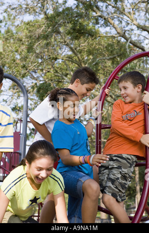 Portrait d'enfants sur les barres de singe dans un terrain Banque D'Images