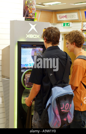 Les mâles adolescents jouer à des jeux d'arcade sur une X-box système. Banque D'Images