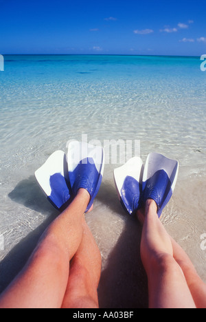 Des couples assis les jambes dans l'eau peu profonde portant des palmes de natation de l'océan Pacifique Sud Fidji parution modèle droit Banque D'Images