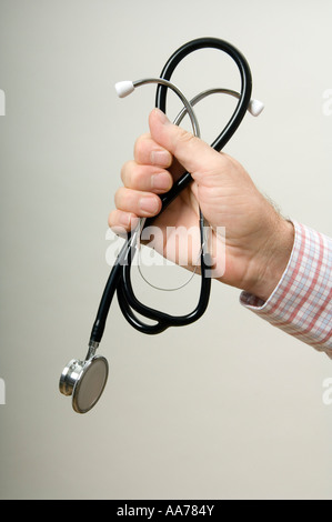 Une main tenant un stéthoscope médical Banque D'Images
