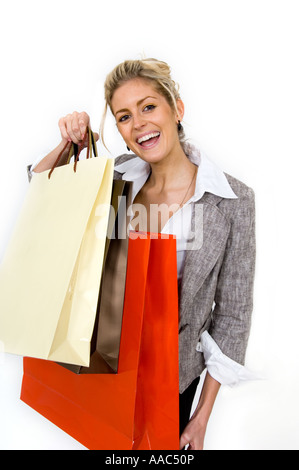 Woman holding up shopping bags Banque D'Images