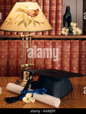 STILL LIFE OF CAP AND GOWN ET DIPLÔME AVEC LAMPE ET LIVRES SUR L'étagère Banque D'Images