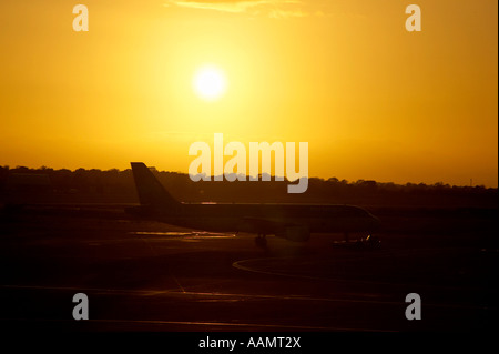 Aer lingus airbus A320 214 remorquer sur la piste de l'aéroport de Dublin, en face du soir coucher de soleil Banque D'Images