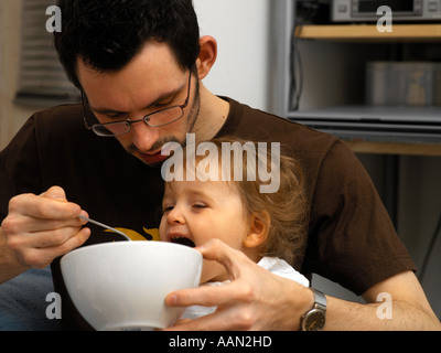 Alimentation père petite fille de 18 mois Banque D'Images