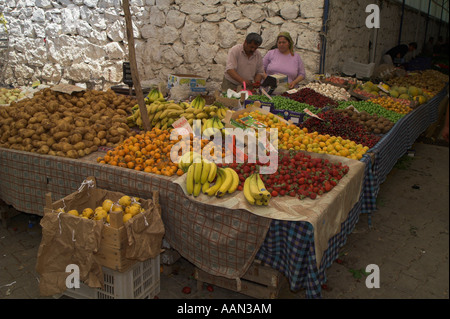 Fruits et légumes à l'affiche au marché turc à Fethiye. L'homme et la femme debout derrière leur étal. Banque D'Images