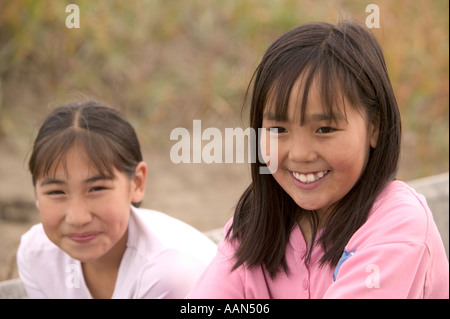 Eva Johnson et Emma Weyiouanna enfants esquimaux sur une île d'Alaska Shishmaref est que s'écouler dans la mer par le wa Banque D'Images