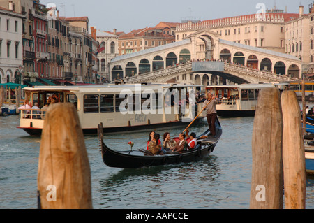 Fin d'après-midi sur une gondole et bus vaporetto sur le Grand Canal près du Pont Rialto Venise. Banque D'Images