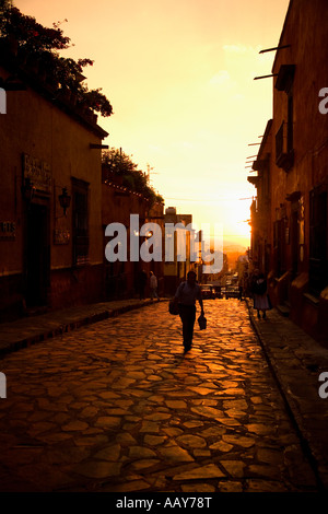 evening shot, twilight, man in center of street, San Miguel de Allende, Mexico, Calle Correo, man walking Stock Photo