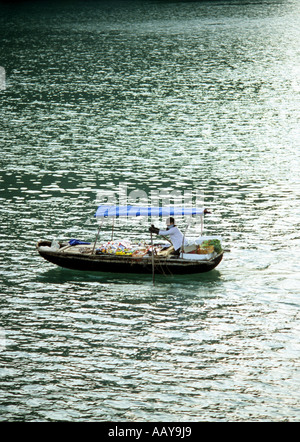 Vendeur dans un bateau, tôt le matin, la baie d'Halong, Vietnam Banque D'Images