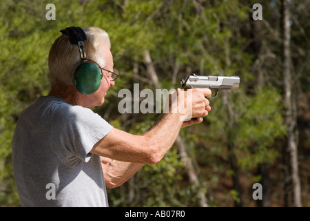 Les personnes âgées de sexe masculin au cours de poing pistolet vise la cible à portée de tir dans la forêt nationale d'Ocala Ocala en Floride USA Banque D'Images