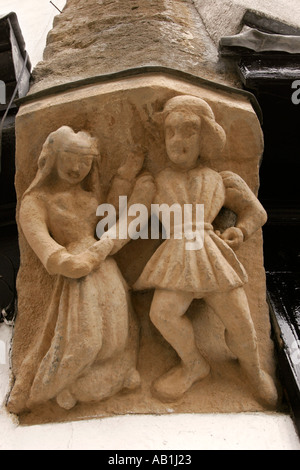 Angleterre Somerset Glastonbury Market Place de l'architecture médiévale en pierre sculpté détail des chiffres sur l'avant boutique Banque D'Images