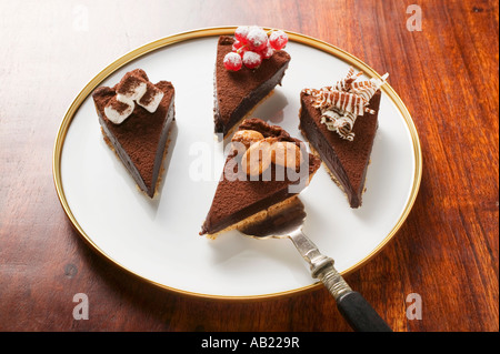 Quatre morceaux de tarte au chocolat avec différentes décorations FoodCollection Banque D'Images