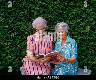 Seniors femmes lecture en plein air Banque D'Images