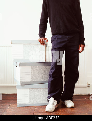Man leaning on cardboard boxes Banque D'Images