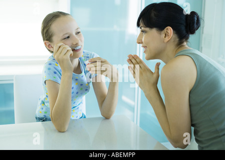 Girl eating ice cream dessert, woman girl with hands clasped Banque D'Images