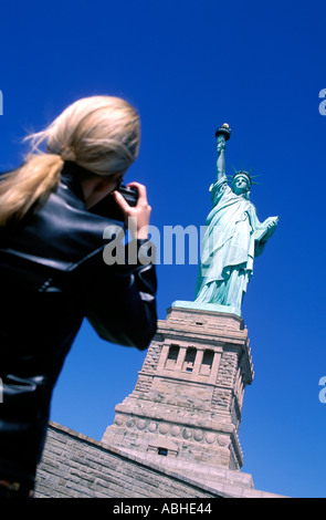 Femme PHOTOGRAPHIANT LA STATUE DE LA LIBERTÉ Banque D'Images