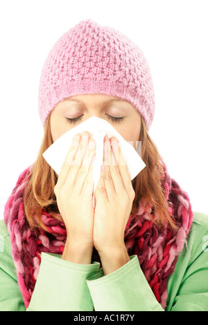 Young woman blowing her nose Banque D'Images