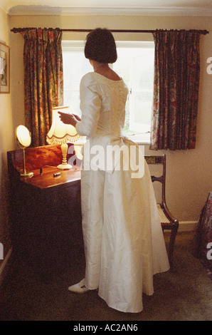 Mariée mettant sur le maquillage avant son mariage dans sa chambre dans les années 1990, Devon, Angleterre, Royaume-Uni Banque D'Images