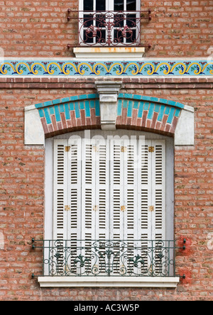 Volets en bois blanc fermé et balcon juliet, arche en brique ornementale avec pierre à clés, Frieze décorative, mur en brique rouge, nord de la france ue Banque D'Images