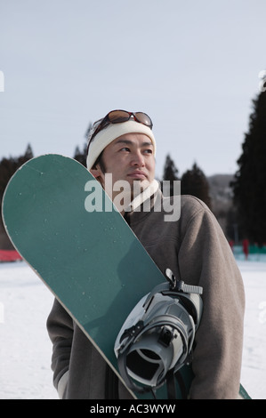 Young man with snowboard Banque D'Images