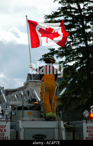 Fireman holding du drapeau national du Canada La fête du Canada, Banff (Alberta) Banque D'Images