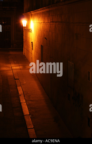 Ruelle faiblement éclairée à Prague la nuit, éclairée par un seul lampadaire projetant des ombres sur les murs. Rue Naprstkova, Prague, Mala Strana la nuit. Banque D'Images