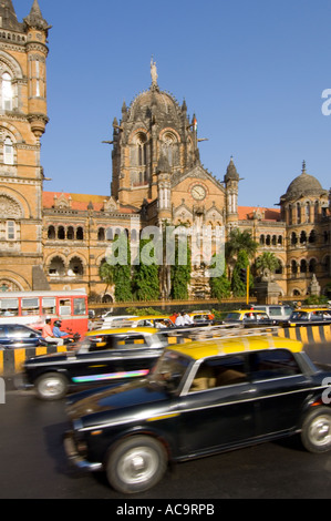 Le Victoria Terminus avec l'heure de pointe voyageant passé en particulier les taxis jaunes et noirs traditionnels de Mumbai. Banque D'Images