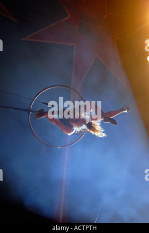 Artiste de cirque à l'aide de acrobat cerceau aérien aussi connu sous le nom de "Cerceau" ou "Lyra" un appareil d'acier circulaire Banque D'Images