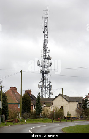 Un mât de téléphonie mobile à côté de maisons à Romsley UK Worcestershire Banque D'Images