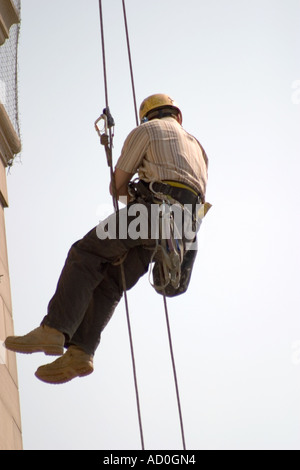 Descente en rappel du travailleur sur le devant de l'Hôtel de ville de Sheffield pour fixer à façade bannière Banque D'Images