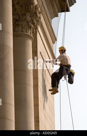 Descente en rappel du travailleur sur le devant de l'Hôtel de ville de Sheffield pour fixer à façade bannière Banque D'Images