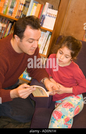 Père en fille hispanique lecture en librairie l'âge de 42 et 6. Rumpus sauvages Librairie pour enfants Minneapolis Minnesota USA Banque D'Images