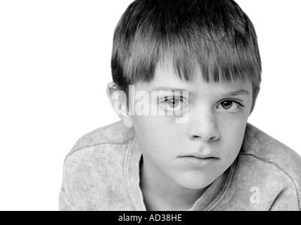 Photo en noir et blanc d'un jeune garçon à la triste. Banque D'Images