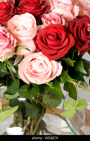 Un bouquet de roses rouges et roses dans un vase sur une table Banque D'Images