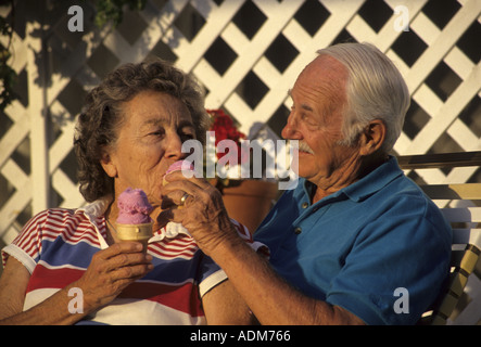 Fun loving attractive senior couple sharing ice cream cones POV Banque D'Images