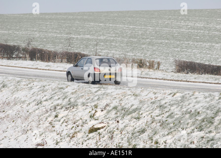 Ford fiesta being driven along a rural road on a cold frosty morning in the uk Banque D'Images