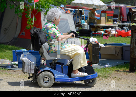 Senior female obtient autour sur un fauteuil roulant motorisé. Banque D'Images