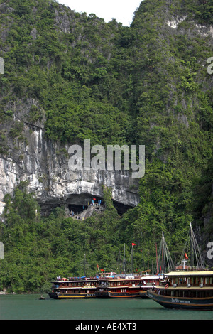 Bateaux en visite à l'extérieur entrée de Hang Sung Sot trois chambre grotte étonnante baie de Halong Vietnam Banque D'Images