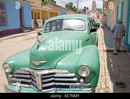 Voiture de collection sur un backstreet à Trinidad, Cuba, avec l'Eglise de Santa Ana au bout de la rue. Banque D'Images