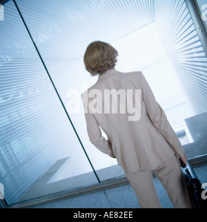 Vue arrière de businesswoman standing in front of window Banque D'Images