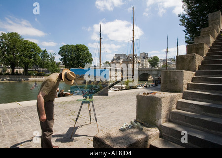 La peinture de l'artiste sur la rive gauche de la Seine près de Pont Neuf Paris France Banque D'Images