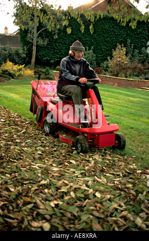 La collecte de feuilles mortes à l'aide d'une tondeuse motorisée polyvalent Bromham Wiltshire, UK Banque D'Images