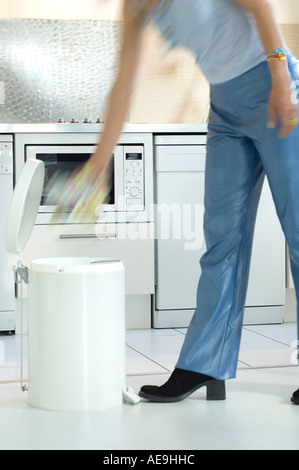 Woman throwing dans la poubelle Banque D'Images