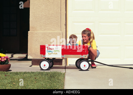 Teenage girl Playing with child Banque D'Images