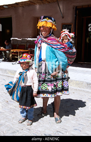 Mère et enfants se tenant dans la rue, Pisac, près de Cusco, Pérou Banque D'Images