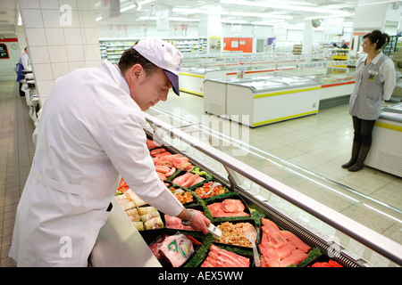 Le contrôle de la qualité des aliments lors de la mesure de température dans un boucher s shop dans un supermarché Banque D'Images